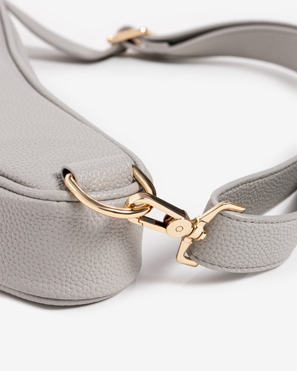 Gold clasp and shoulder strap detail on Ten Twenty Dubai Skyline padel racket bag in light grey vegan leather