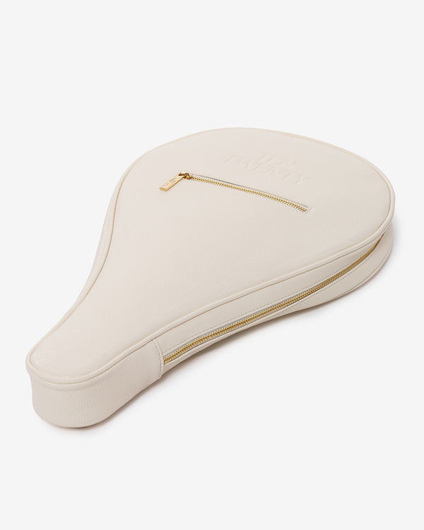 Side profile of Ten Twenty Jumeirah Pearls padel racket bag showing structured form and gold zip in cream vegan leather
