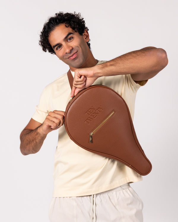 Man holding Ten Twenty Arabica Coffee premium padel racket bag in tan brown vegan leather - Ten Twenty UAE