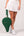 Woman carrying Ten Twenty Emirates Palms premium padel racket bag in forest green vegan leather with gold hardware - Ten Twenty UAE