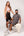 Man and woman with Ten Twenty Jumeirah Pearls padel racket bag in cream vegan leather - lifestyle shot UAE