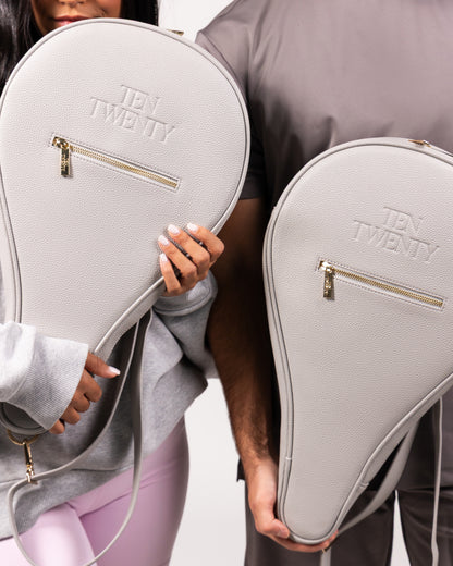 Couple holding Ten Twenty Dubai Skyline premium padel racket bags in light grey vegan leather - Ten Twenty UAE