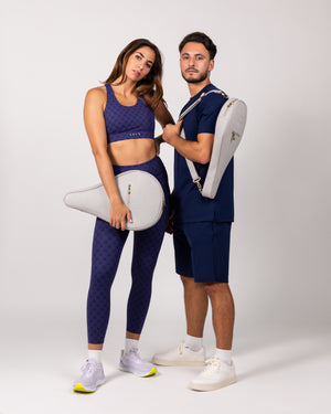 Man and woman in sportswear holding Ten Twenty Dubai Skyline padel racket bags in light grey vegan leather - Ten Twenty UAE