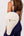 Woman wearing Ten Twenty Jumeirah Pearls premium padel racket bag in cream vegan leather as shoulder bag - UAE