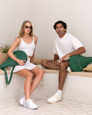 Man and woman with Ten Twenty Emirates Palms padel bags in forest green - lifestyle shot Dubai