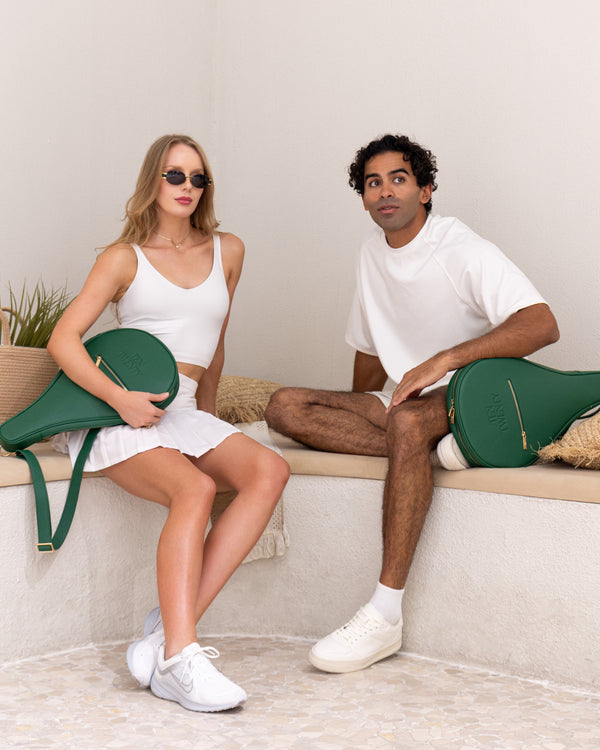 Man and woman with Ten Twenty Emirates Palms padel bags in forest green - lifestyle shot Dubai